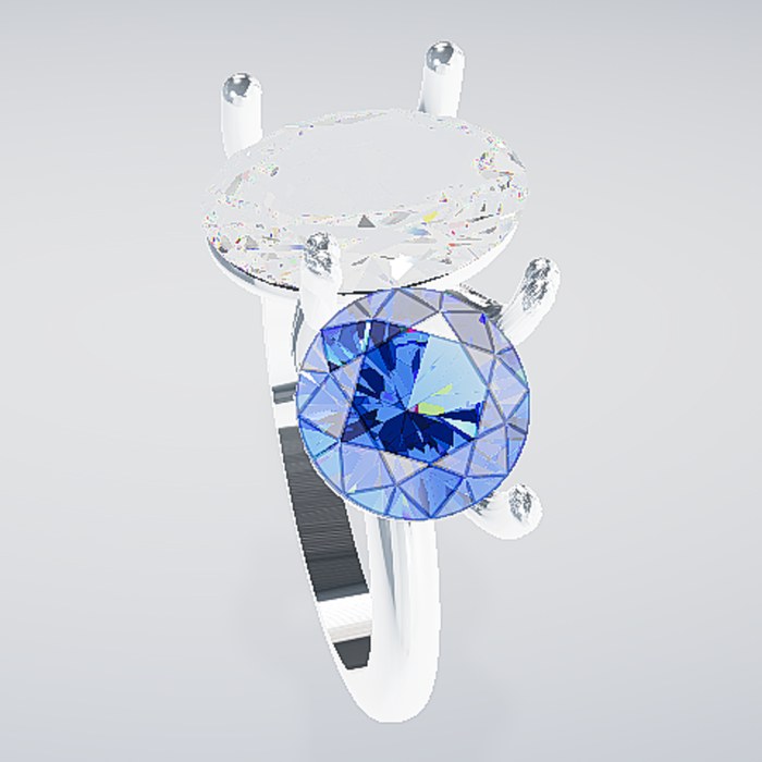 A round blue sapphire beside an oval diamond on a platinum ring