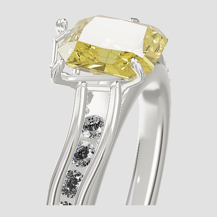 A yellow radiant diamond on a white gold ring